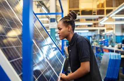 Woman in front of solar panel